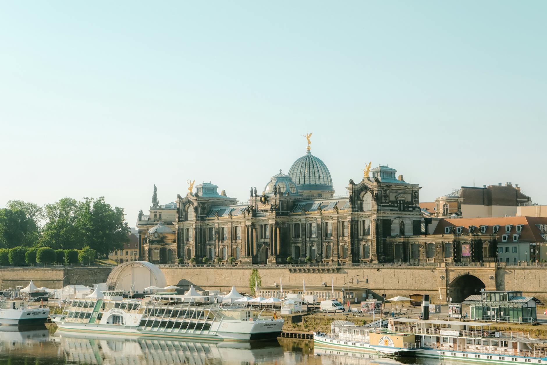 The Academy of Fine Arts Dresden and historic skyline rise above boats on the Elbe River, capturing the iconic waterway setting for European river cruises departing from Berlin.
