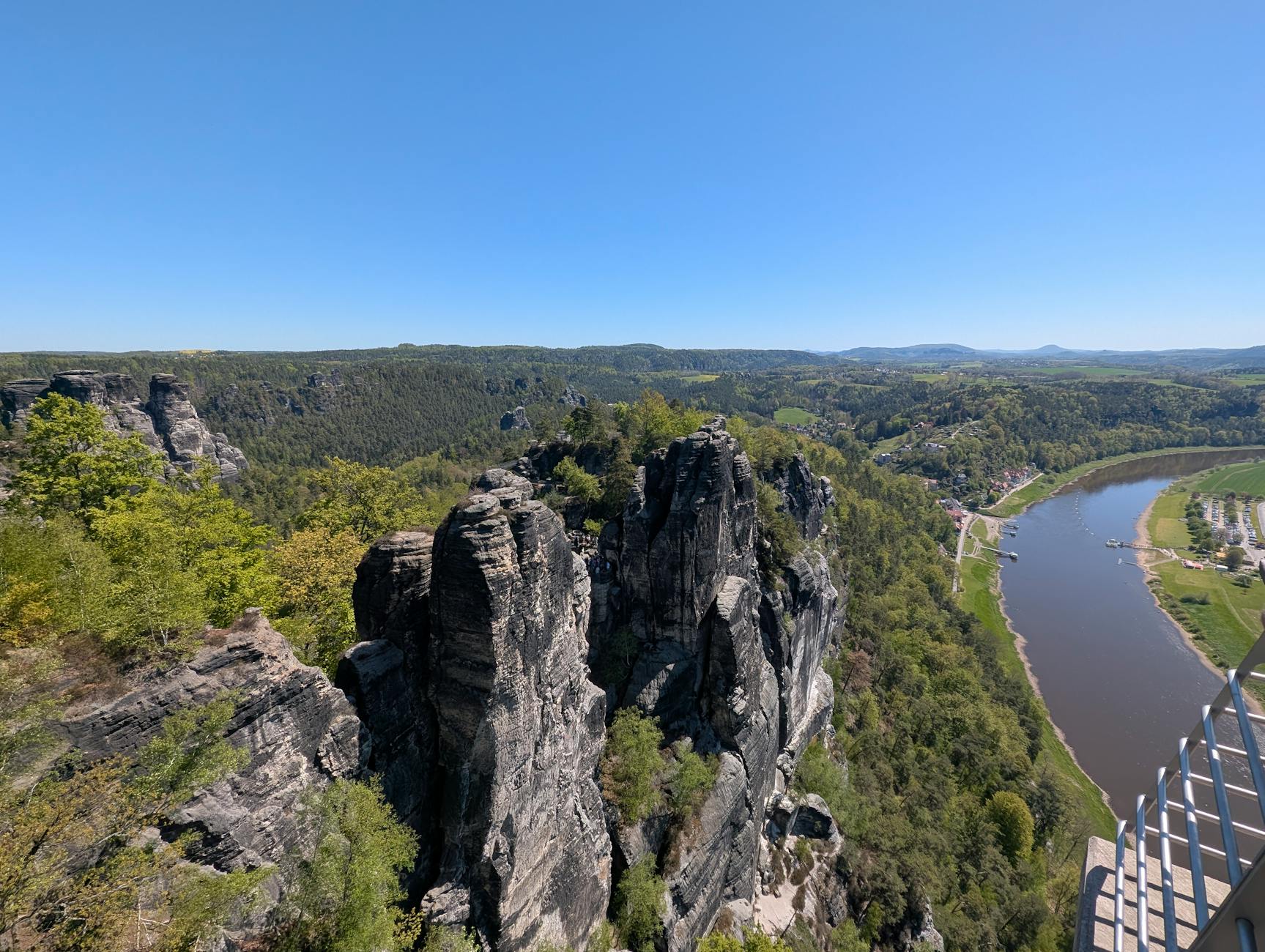 Aerial view of the Elbe Sandstone Mountains' towering pillars rising above the Elbe River valley, showcasing the dramatic landscape encountered on the Berlin-to-Prague river cruise route.
