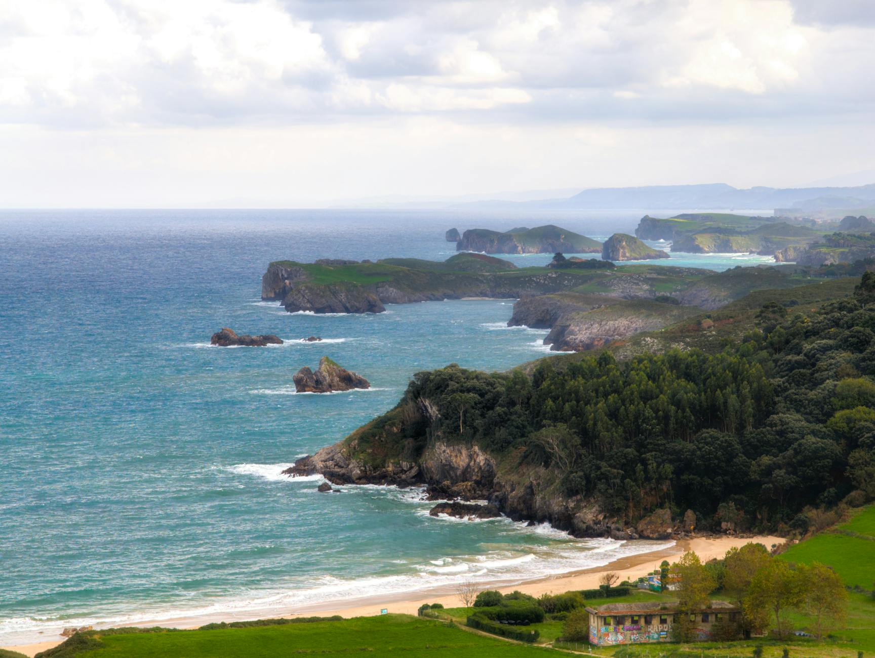 Dramatic cliffs and rugged coastline of Asturias, Spain, overlooking the vast Atlantic Ocean — the waters cruise ships traverse during a Bay of Biscay and Atlantic crossing.