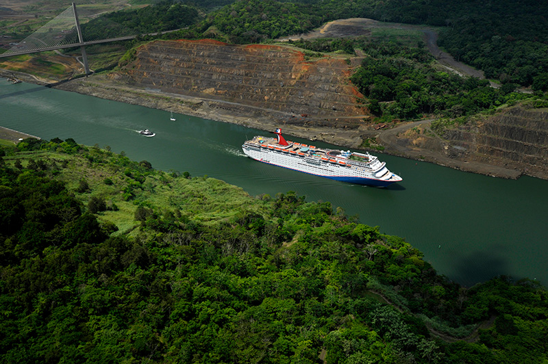 Carnival Elation cruise ship transiting the Panama Canal with distinctive blue hull.