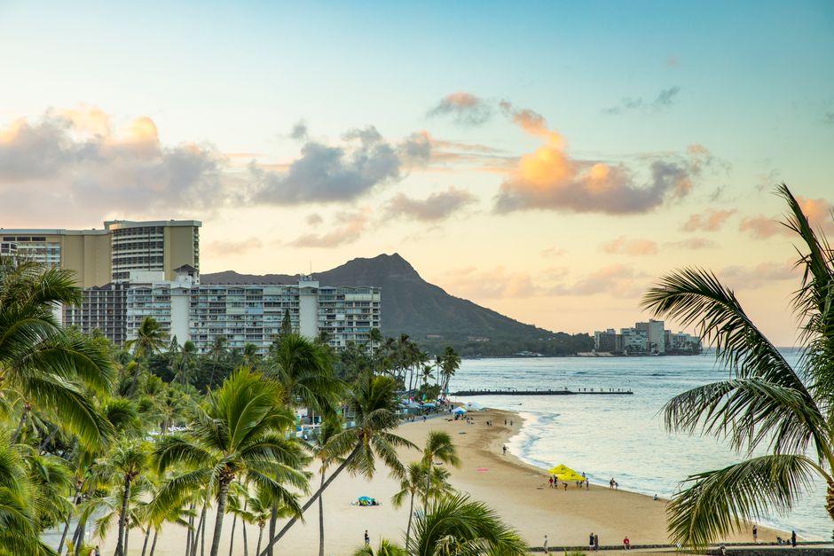 Waikiki Beach and Diamond Head crater bathed in warm sunset light, evoking the golden-hour arrival view cruise passengers experience approaching Honolulu from the sea.