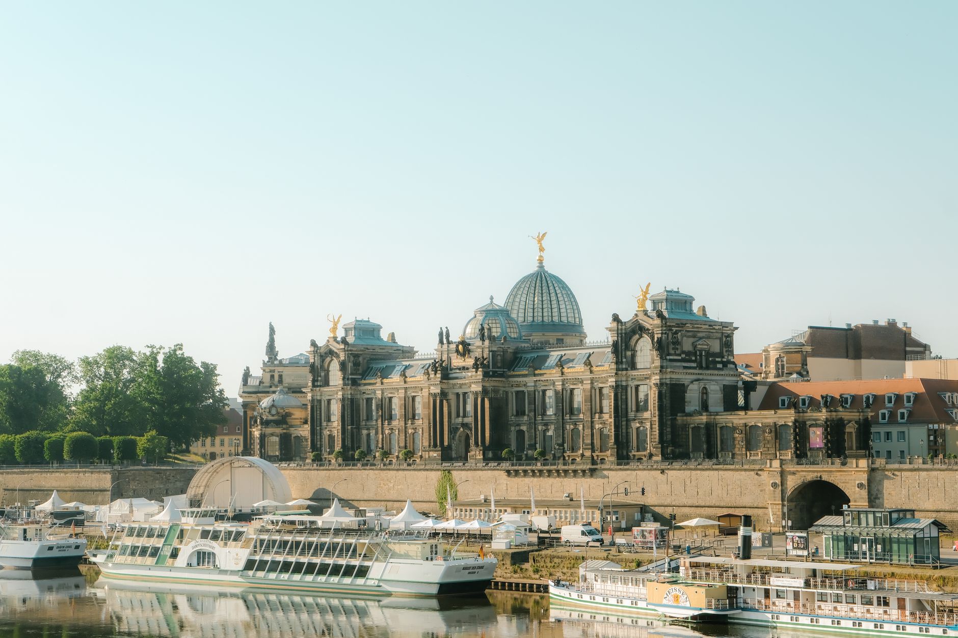 The Academy of Fine Arts Dresden and historic skyline rise above boats on the Elbe River, capturing the iconic waterway setting for European river cruises departing from Berlin.