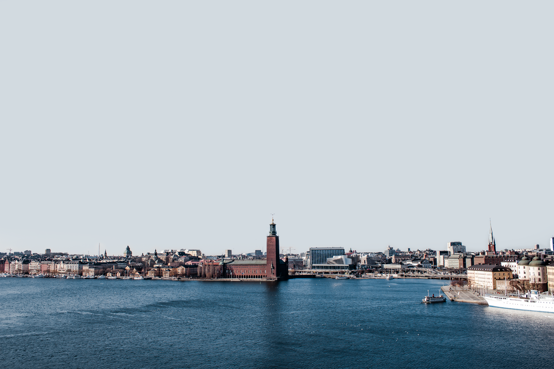 Stockholm's historic waterfront showcasing ornate Nordic architecture reflected in calm Baltic waters, a signature port of call on Eastern European cruise itineraries from Amsterdam.