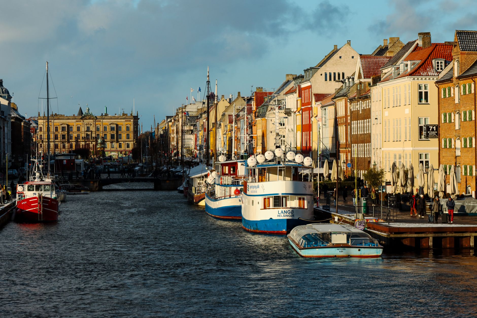 Vibrant Nyhavn canal in Copenhagen, Denmark, lined with colourful waterfront buildings and traditional boats — a signature Northern Europe cruise port of call.