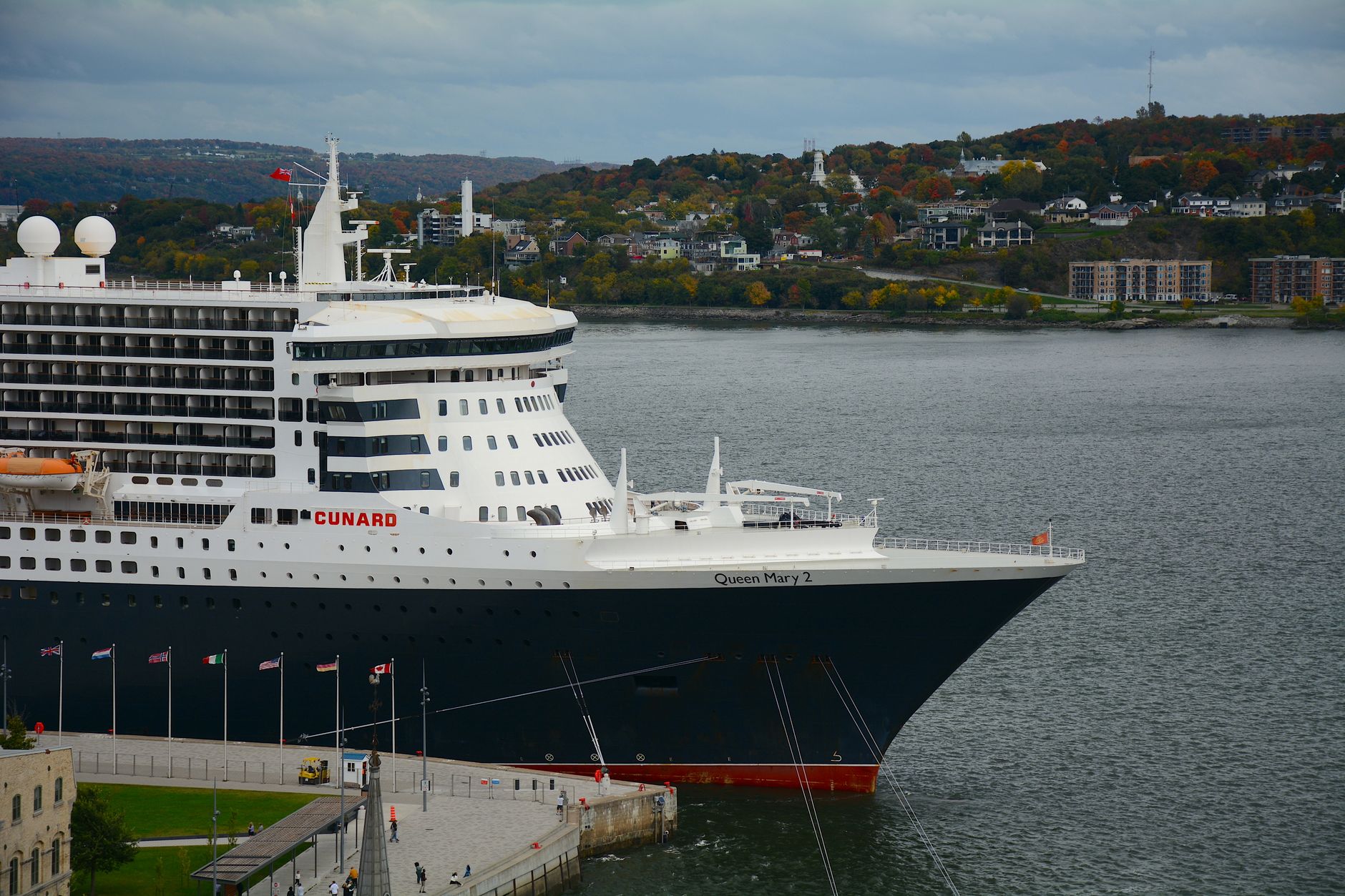 The Cunard Queen Mary 2, distinguished by her ocean-liner silhouette and dark hull, seen at harbor — the purpose-built transatlantic liner featured in this section on the classic North Atlantic crossing.
