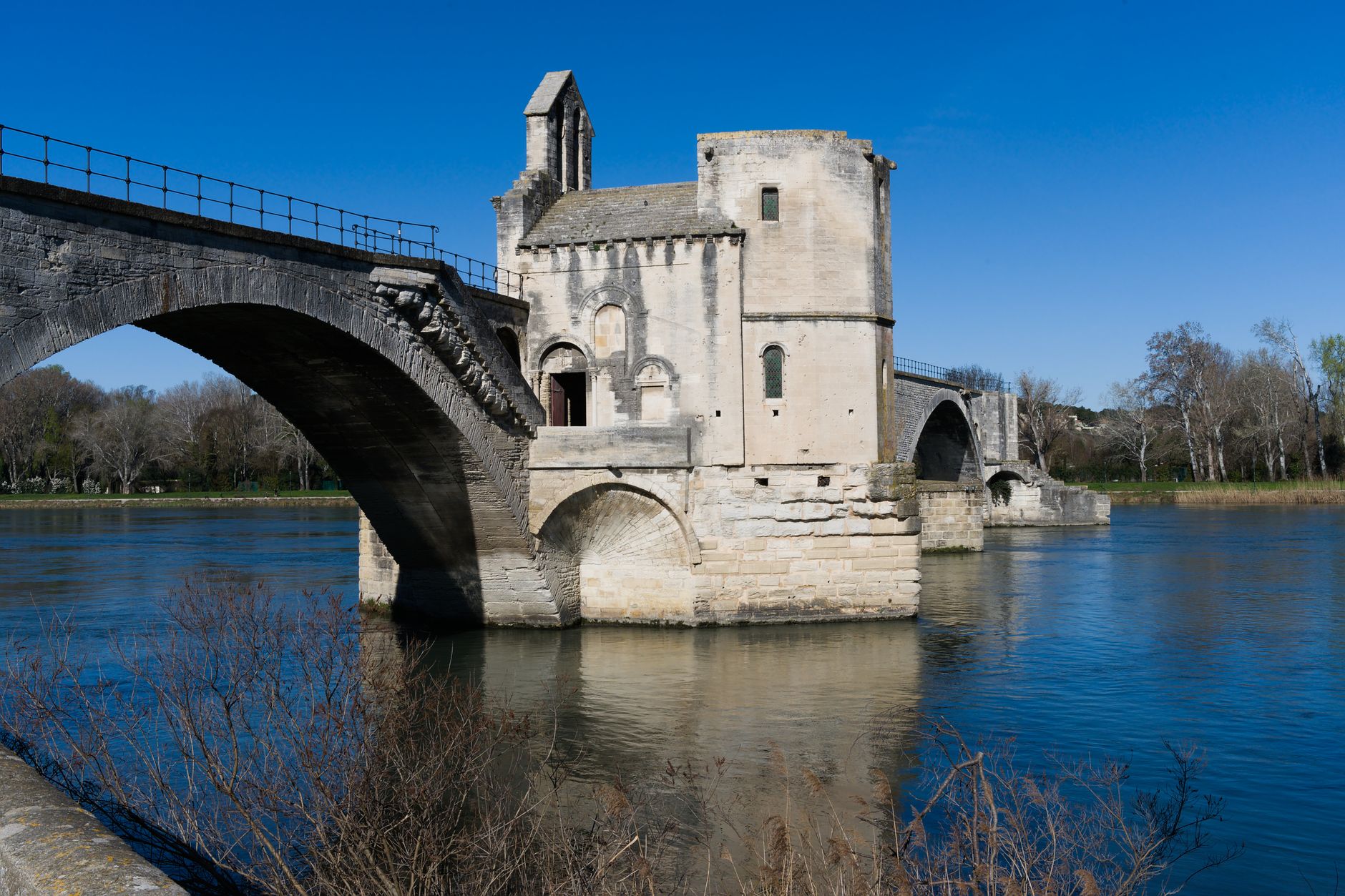 The historic Pont Saint-Bénézet bridge spanning the Rhône River in Avignon, a key port of call on river cruises departing from nearby Arles in Provence, France