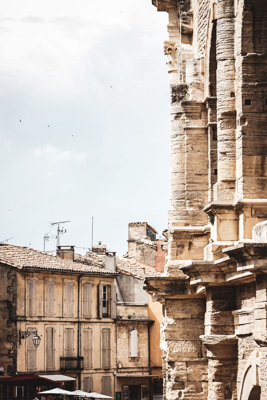 Ancient Roman architecture meets classic French town view in Arles.