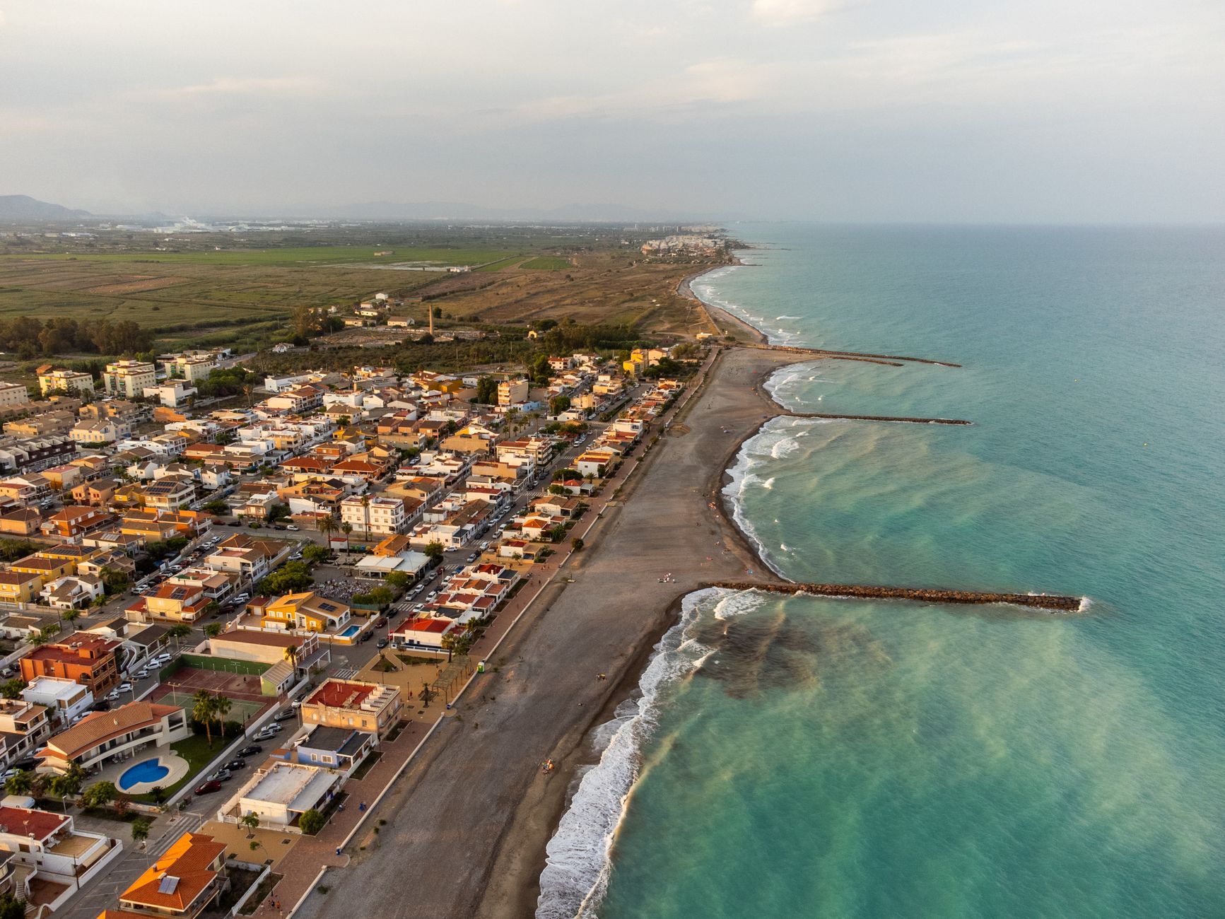 Aerial panorama of the Valencia coastline showcasing sun-drenched architecture and the sparkling Mediterranean, evoking the charm of Iberian coastal towns along a Western European cruise route.