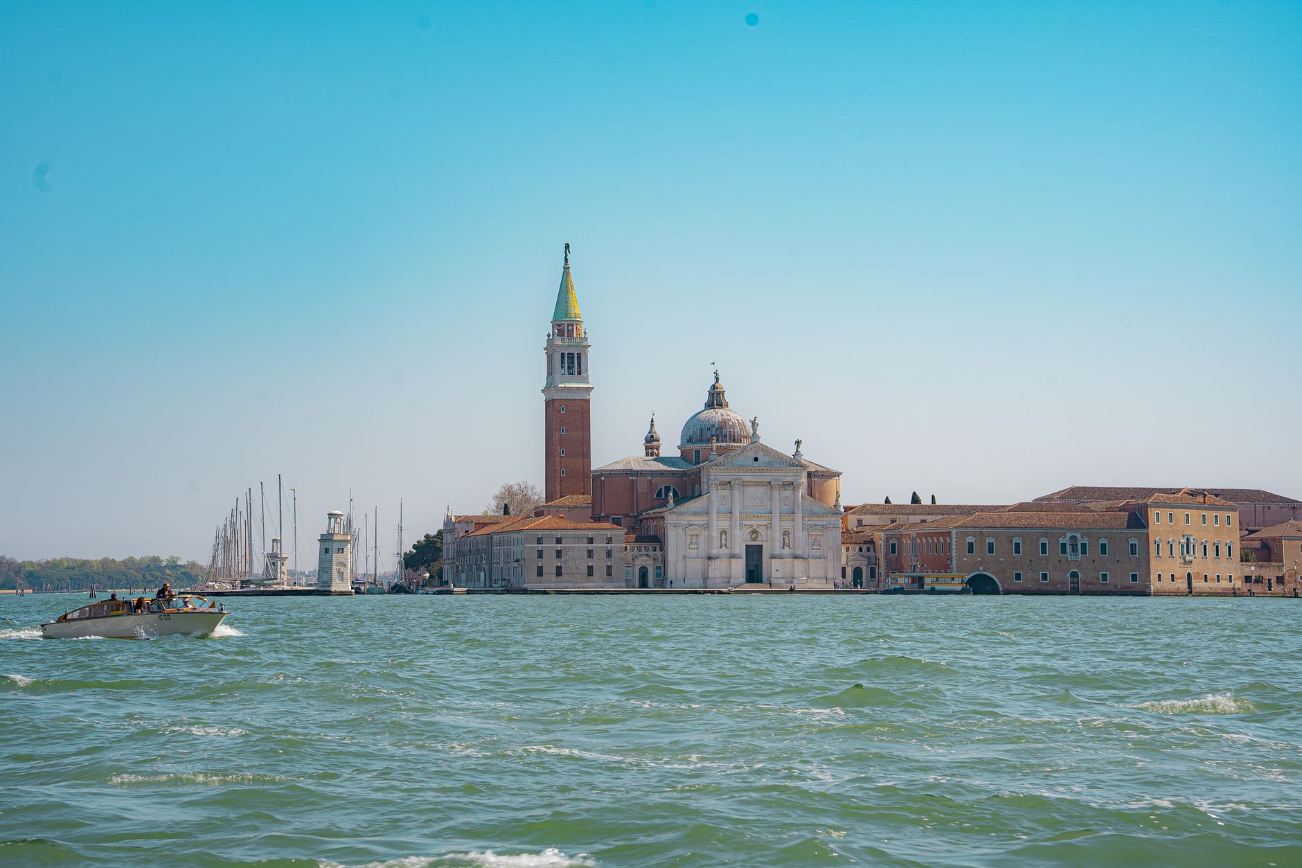 San Giorgio Maggiore island and its iconic church rising from the Venetian lagoon, viewed across the water as if approaching Venice by boat