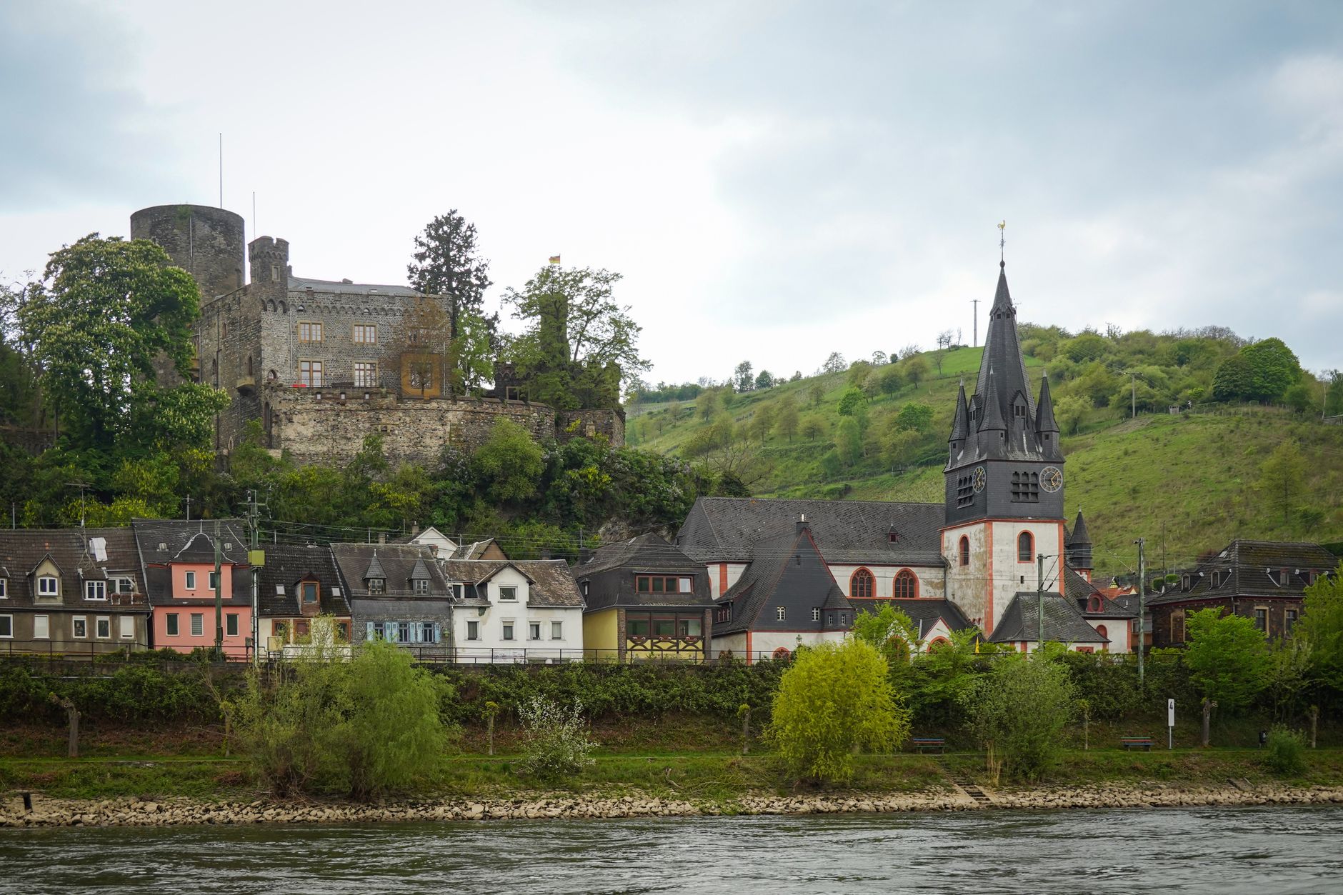 Picturesque view of Bacharach village and the medieval Stahleck Castle perched above the Rhine River, a quintessential stop on European river cruises departing from Zurich through Germany's storied river valleys.