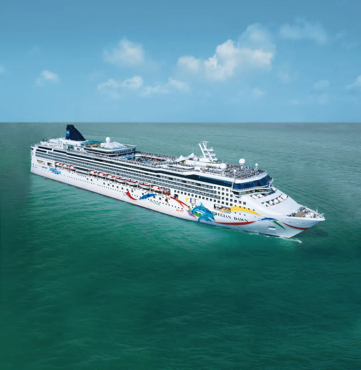 Norwegian Dawn cruise ship sailing starboard side at sea in natural light
