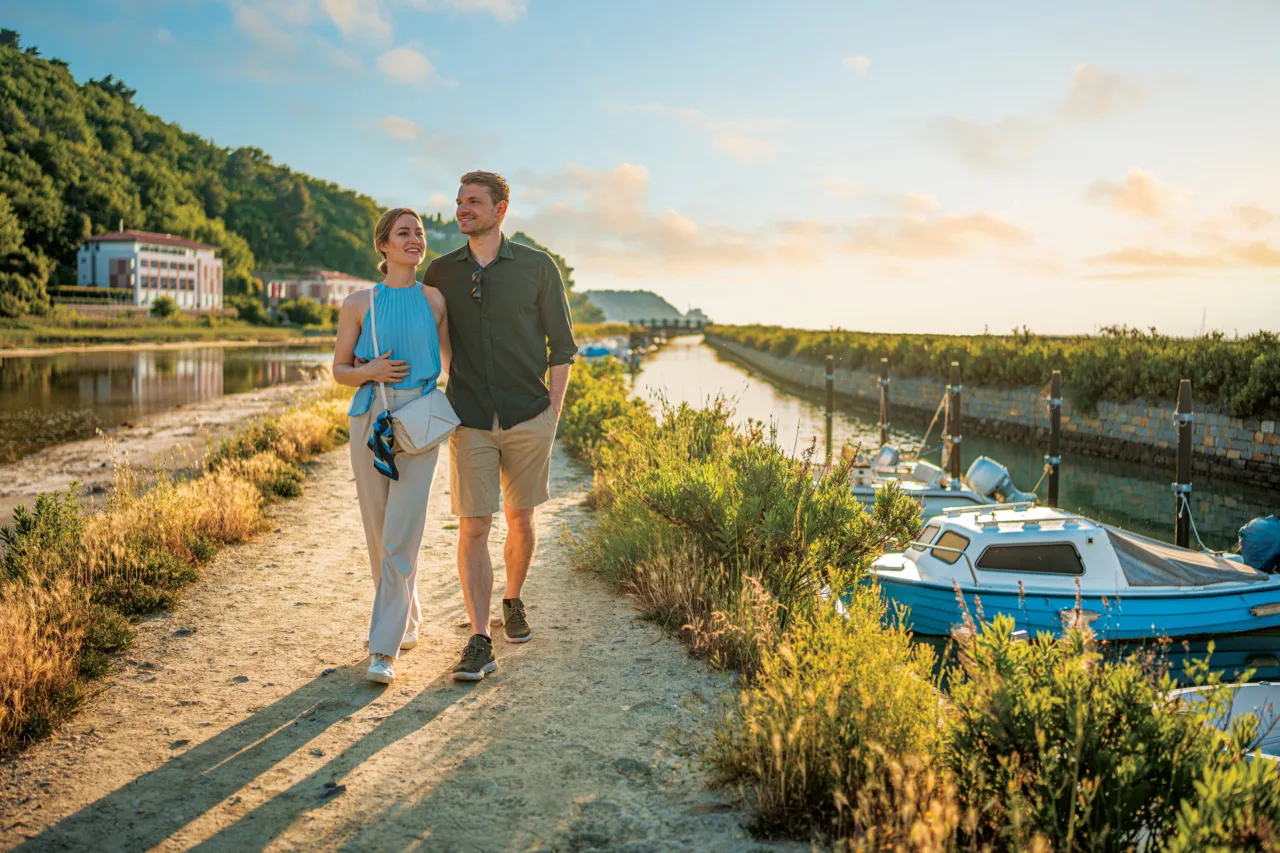 Lovely Caucasian couple walking hand in hand in a alt evaporation pond at Mediterranean sea, as they discover hidden gems along the way.
