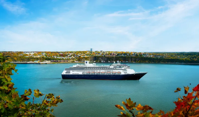 MS Volendam cruise ship sailing the St. Lawrence River in fall with Quebec scenery