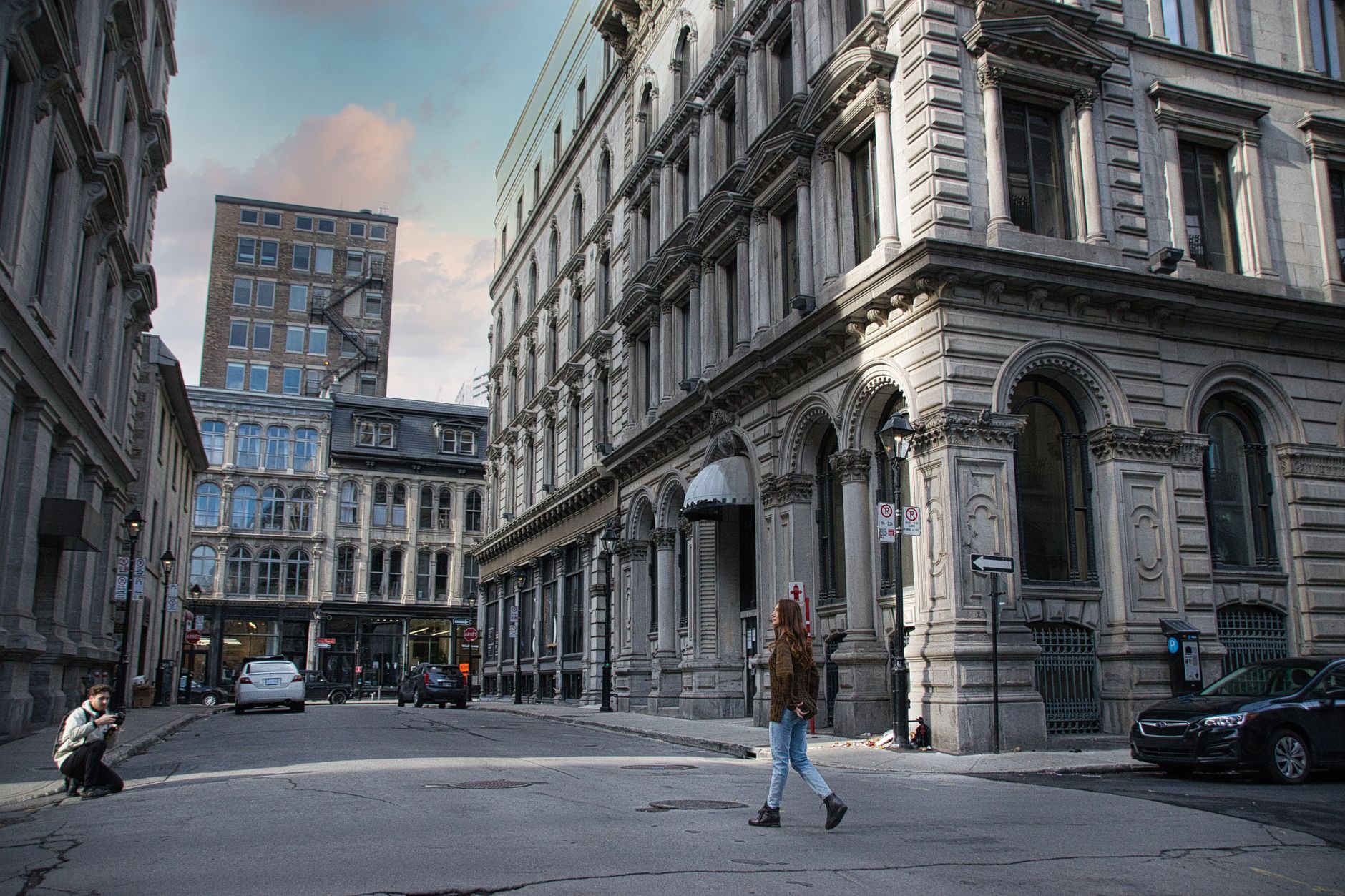 Historic stone buildings lining a quiet Old Montreal street, showcasing the charming architectural character of the district near the cruise departure point.