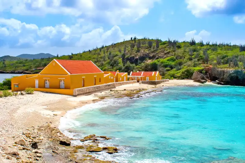 Aerial view of Washington Slagbaai National Park coastline in Bonaire with turquoise Caribbean waters and lush tropical landscape.