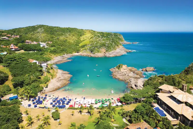 Aerial view of turquoise waters and sandy beach at Ferradurinha in Brazil's Atlantic coast.
