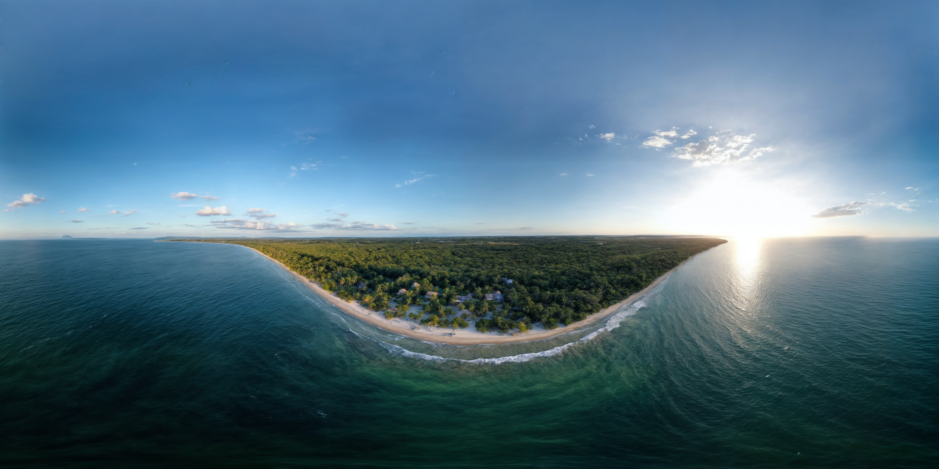 Aerial panorama of Santa Marta's Caribbean coastline at sunrise, with turquoise waters meeting lush green headlands along Colombia's northern coast near Cartagena