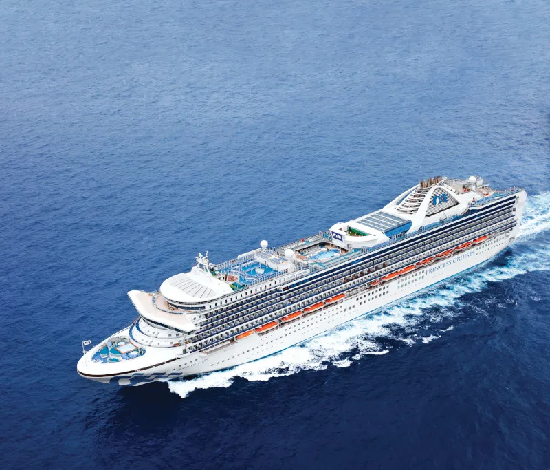 Grand Princess cruise ship at sea with an aerial view of the vessel on open water.