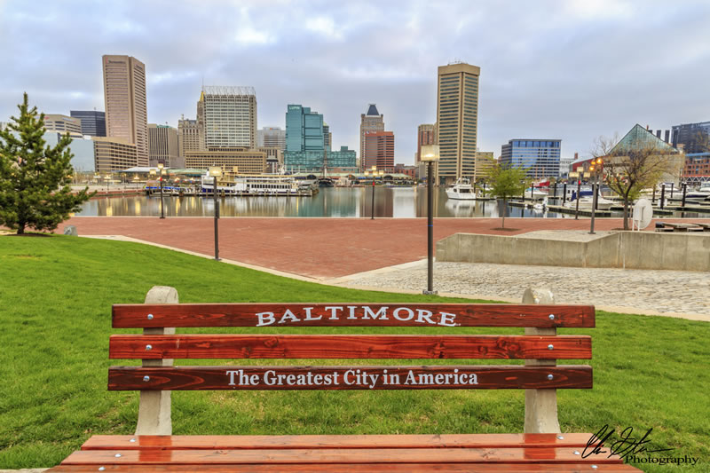 Baltimore waterfront bench with city skyline and Inner Harbor in background