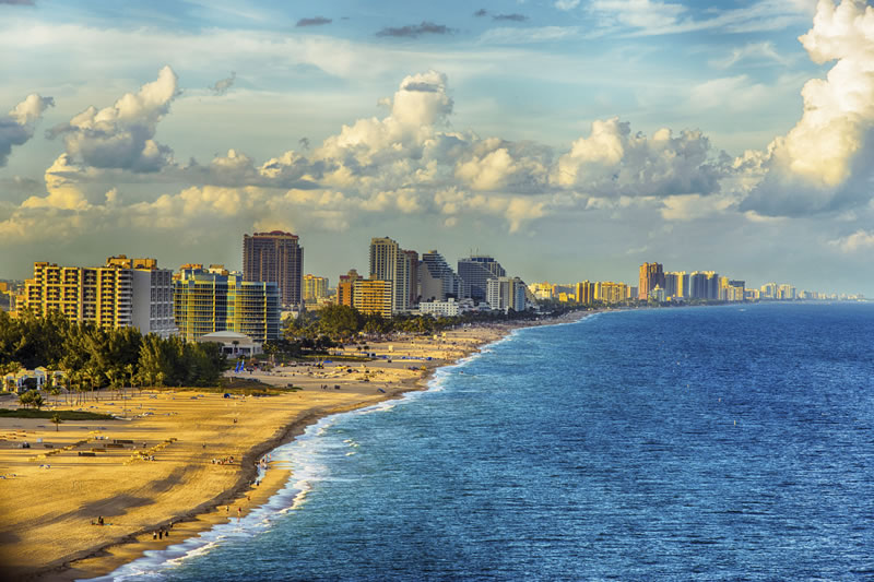 Fort Lauderdale beach with high-rise buildings and dramatic cloudy sky