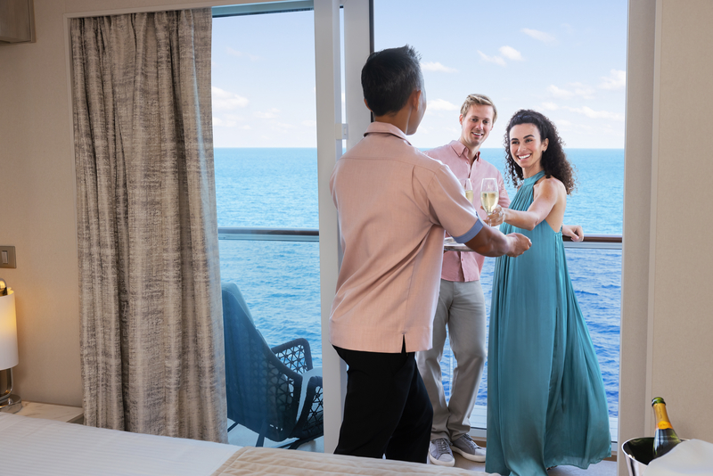 Couple toasting champagne on cruise ship balcony with ocean view