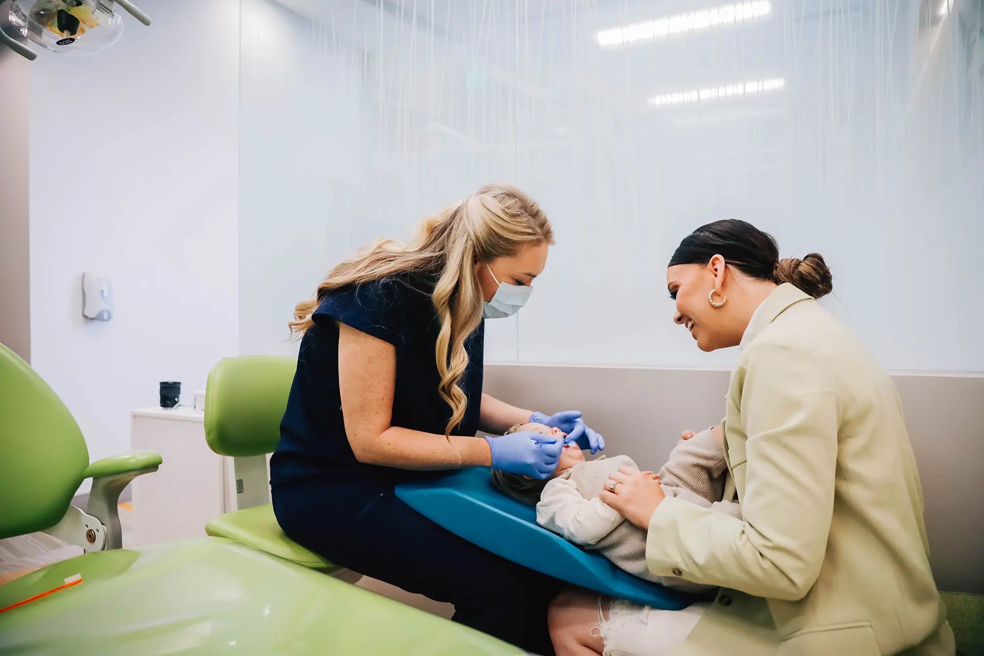 Pediatric dentist treating a young patient with mom nearby, restorative dentistry in San Marcos