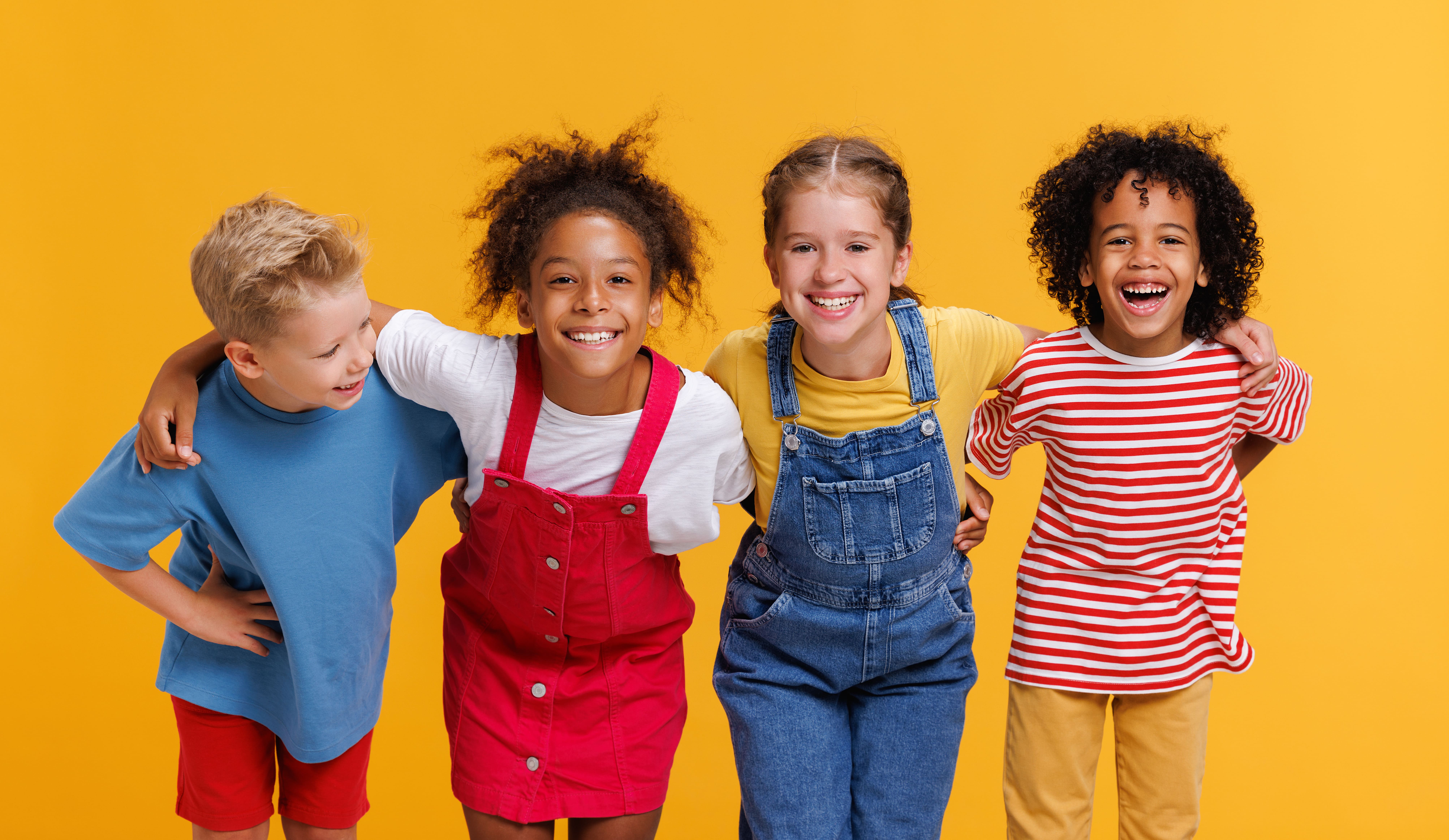 Four smiling kids standing together