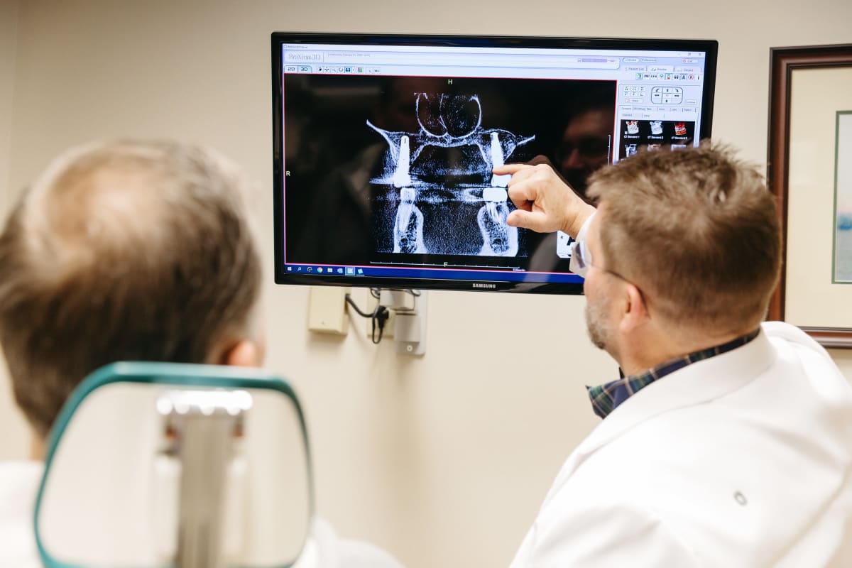 Patients viewing dental imaging on a monitor during consultation