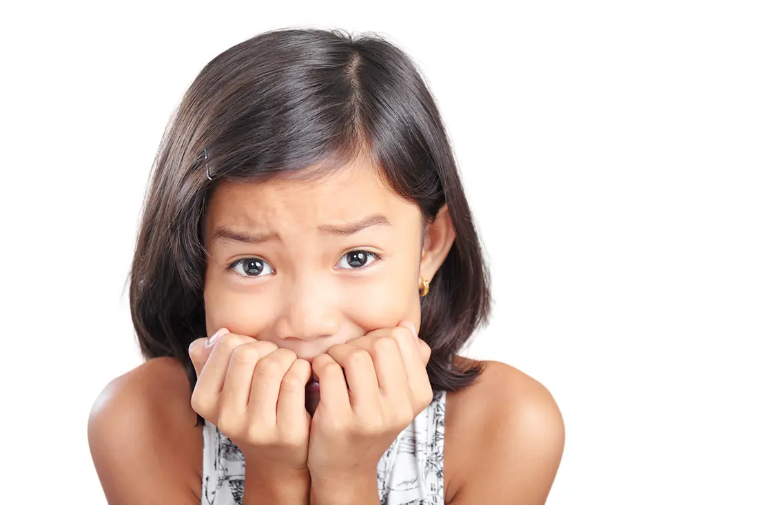 Worried girl holding her hands to her mouth