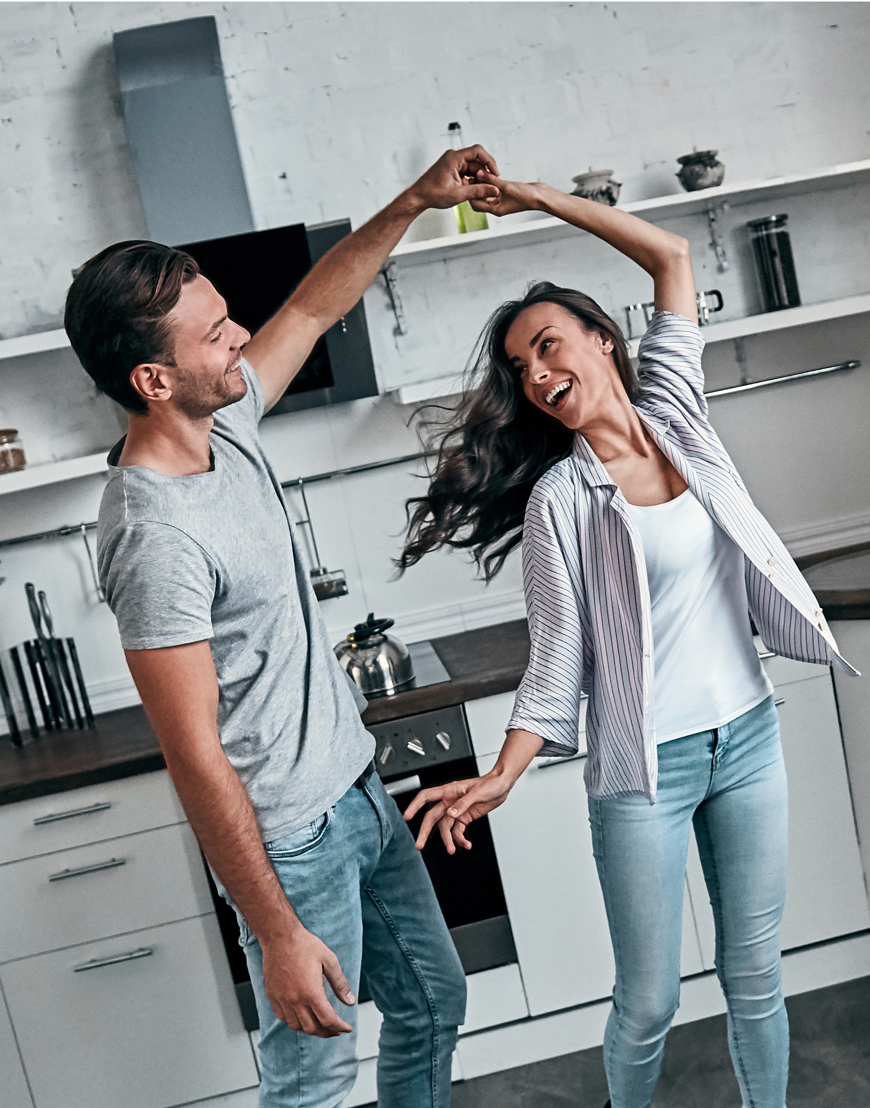 Happy family photo of couple dancing in kitchen together