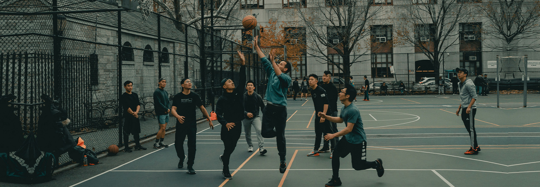 a group of people playing basketball