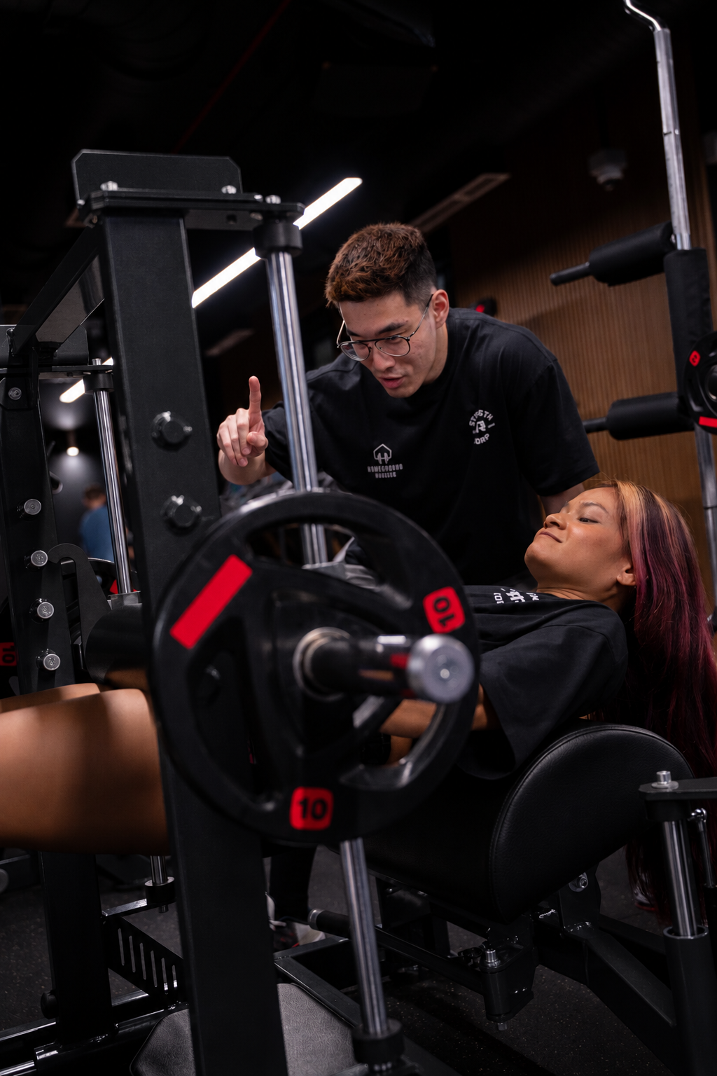 Strength Corp coach guiding a client through a strength training exercise