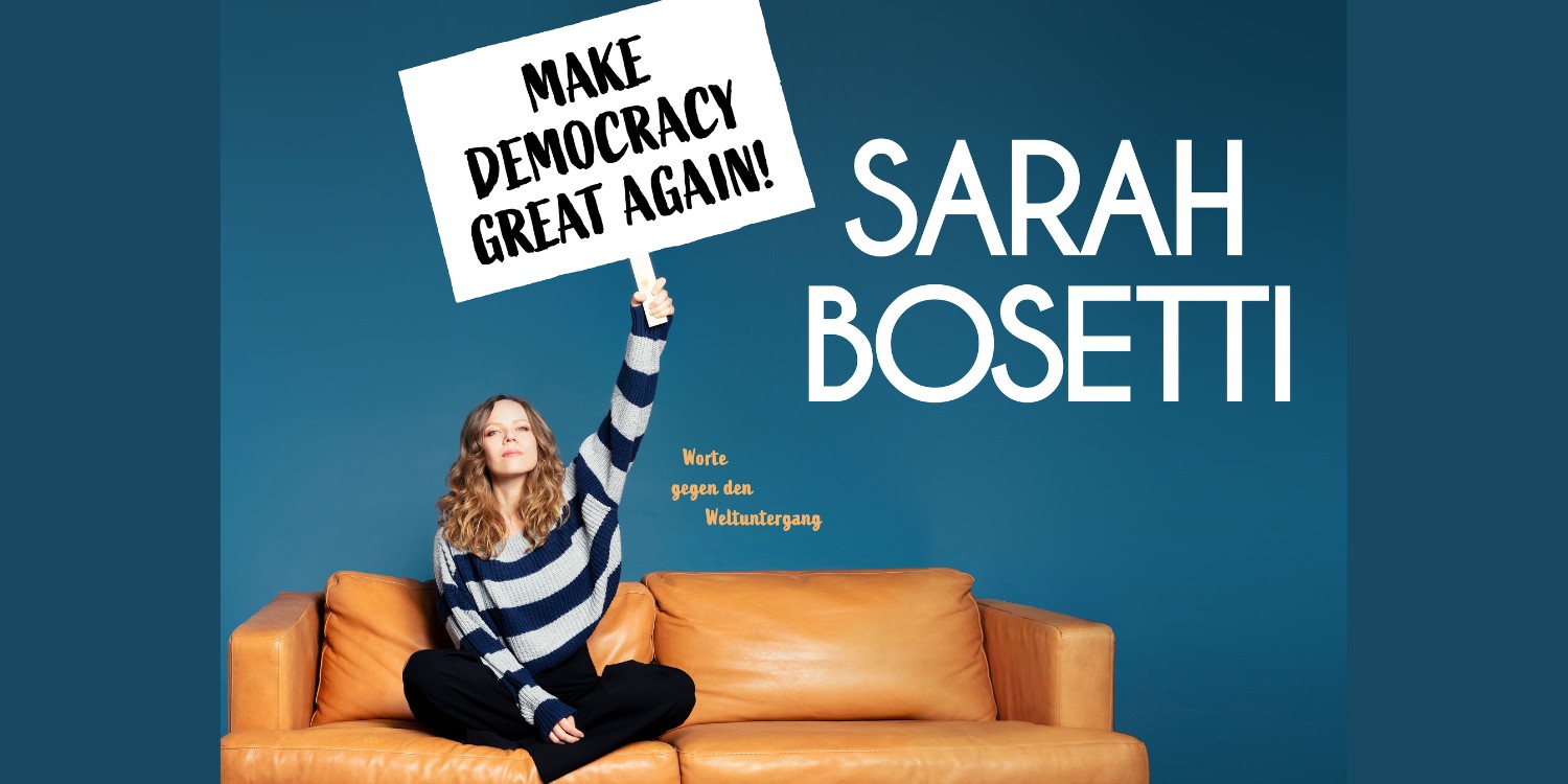 Sarah Bosetti hält ein Schuld hoch: Make Democracy Great Again! 