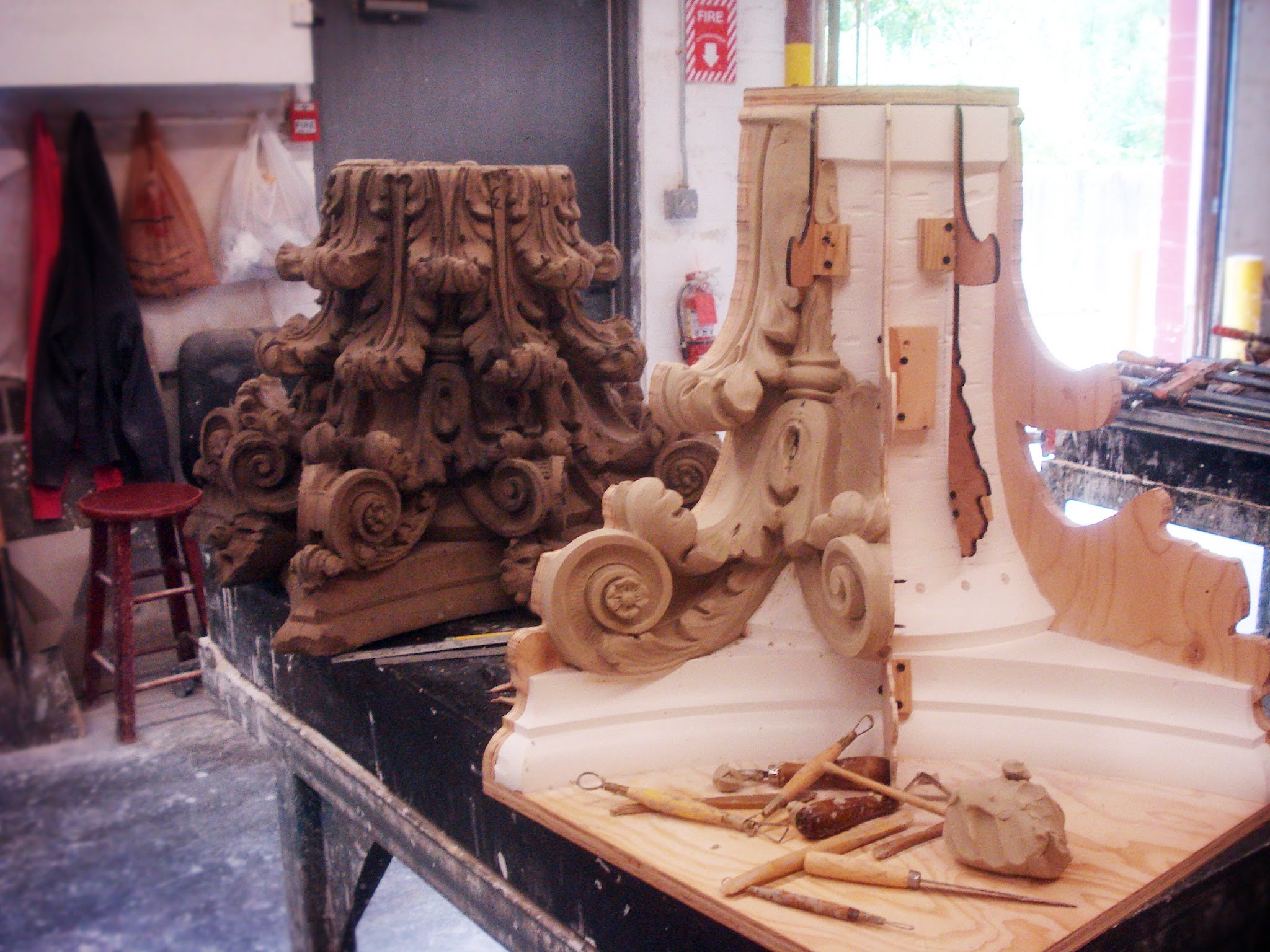 Here we see the original stone with our assembly. Notice the wood profiles to help guide the sculpting.