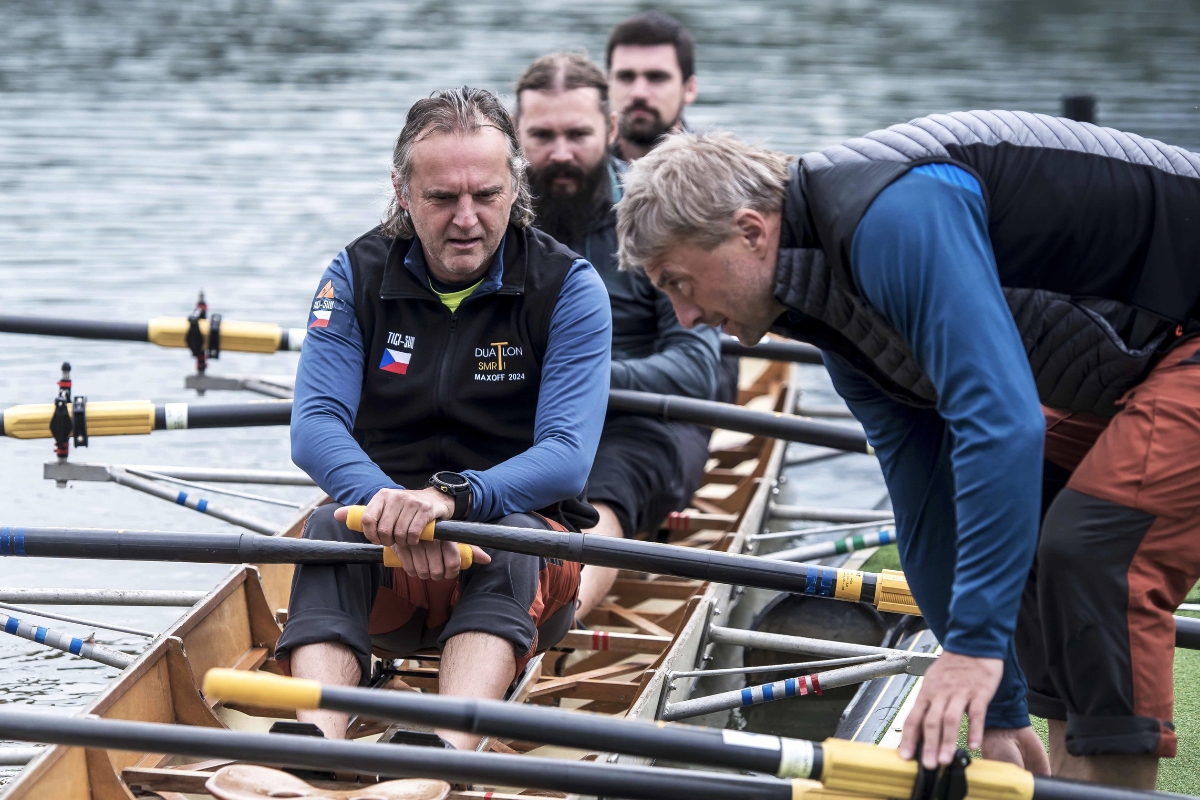 Crew sitting in a rowing boat holding the oars