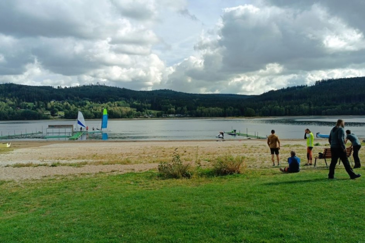 Beach at Lipno with sailing boats in the distance