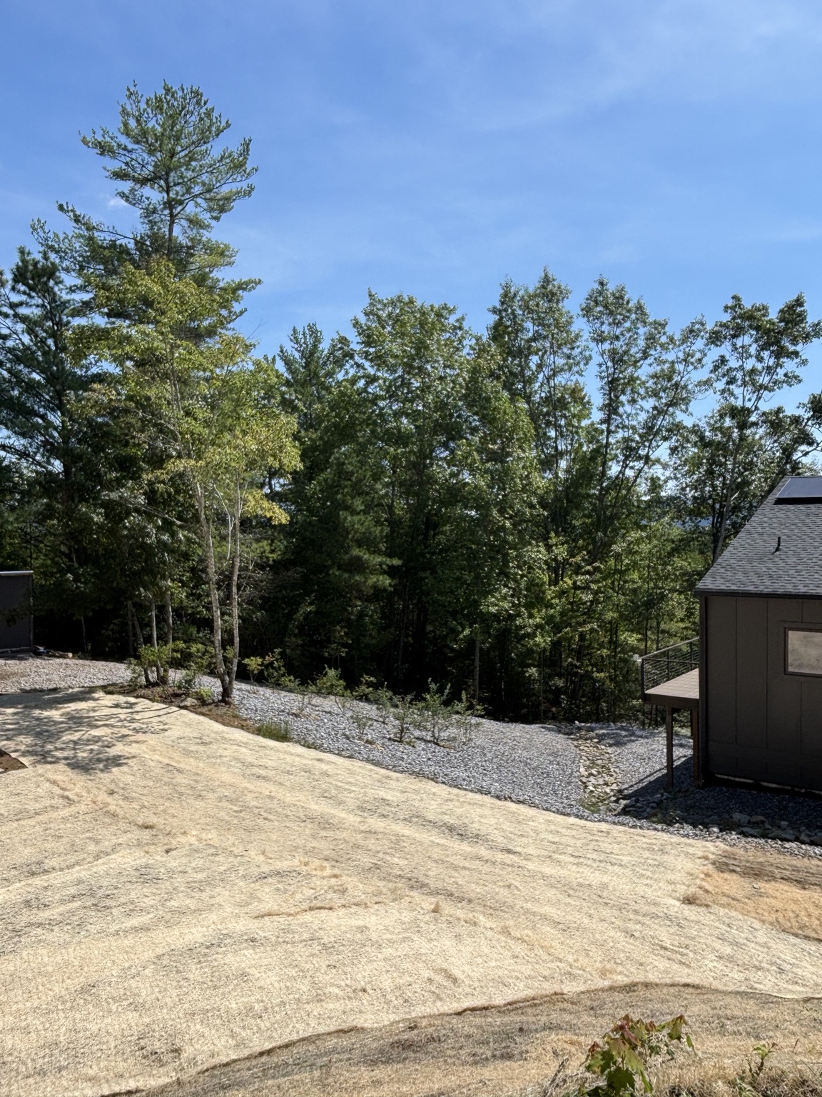 Completed erosion control matting and stone stabilization around the home
