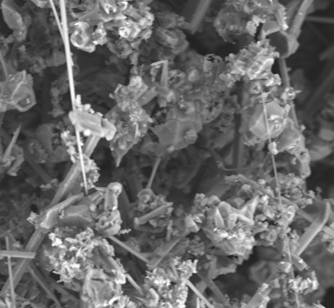 Close-up of crystalline mineral structures with rough, irregular shapes and fine details.