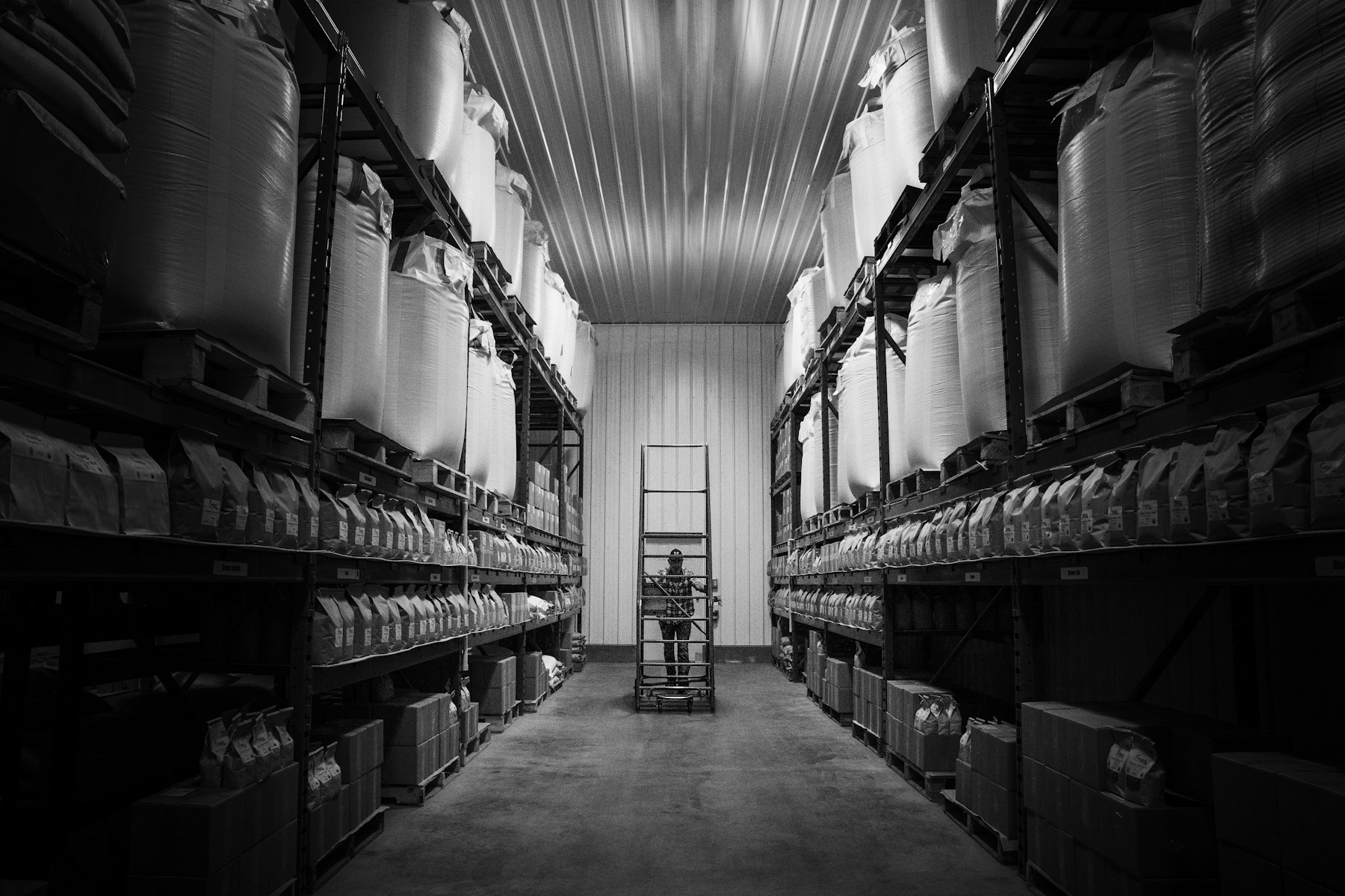 Storeroom aisle with racked materials and spare parts