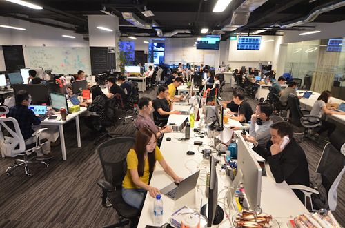 A group of people working on computers in an office