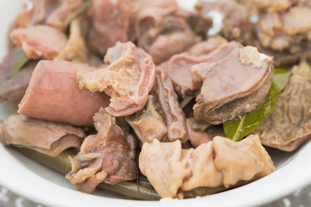 Traditional Thắng Cố dish made with beef, or horse meat and organs, served in a white bowl.
