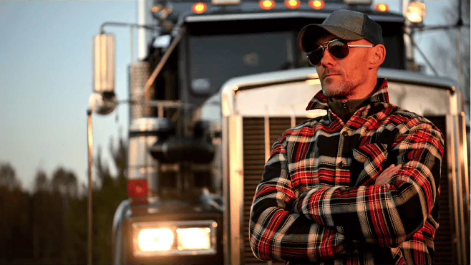 Owner‑operator standing proudly before a semi‑truck, ready to buy their first rig.