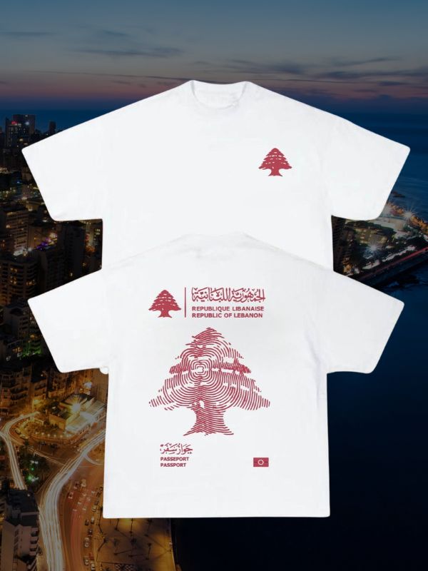 White t-shirt with red cedar tree graphic and Lebanon passport text in Arabic and English.