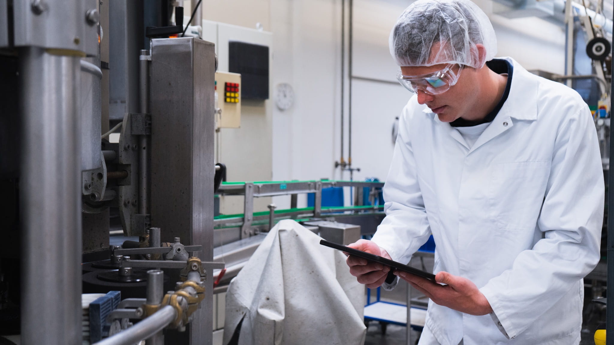 An operator using a touchscreen to log and track production events.