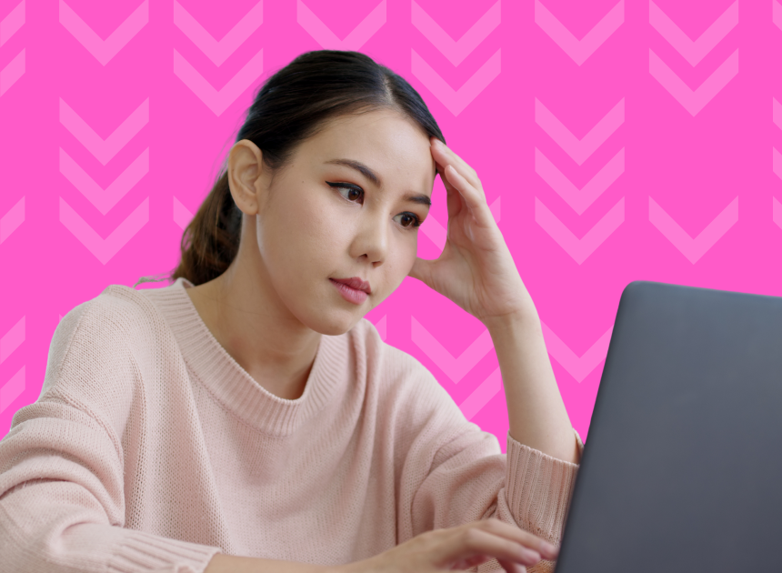 A frustrated woman stares at her laptop screen