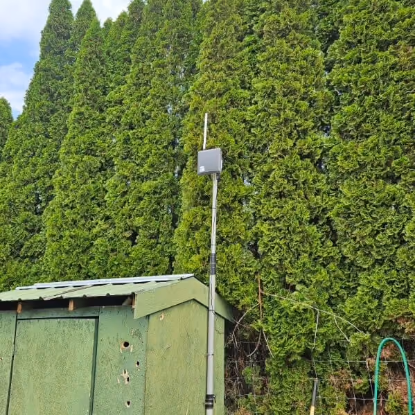 Verdi wireless gateway gen 2 mounted on a metal post attached to a shed