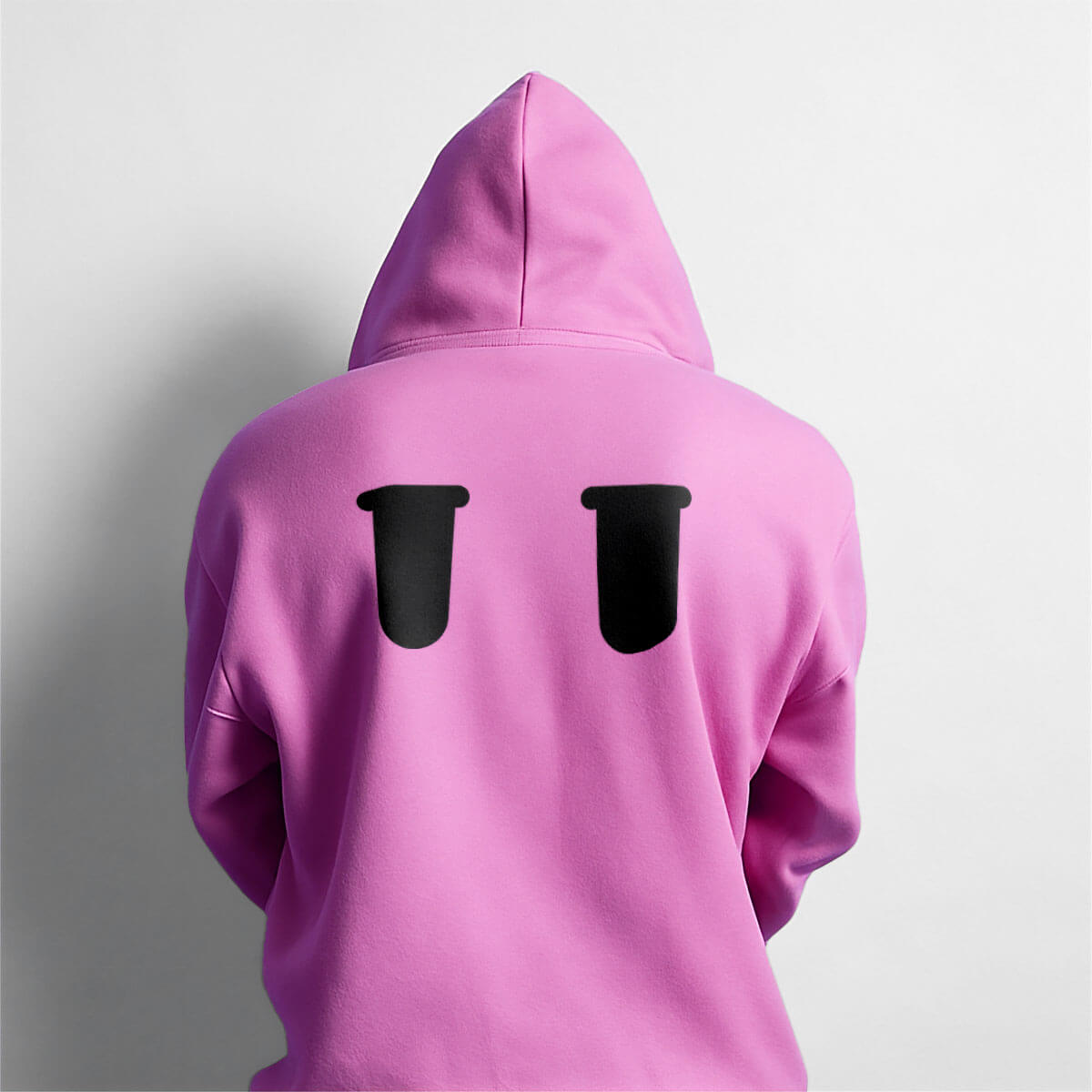 Merch hoodie in pink with dismayed eye expressions back graphic designed by Studio Kiln as part of their Fellowkids rebrand / brand identity.