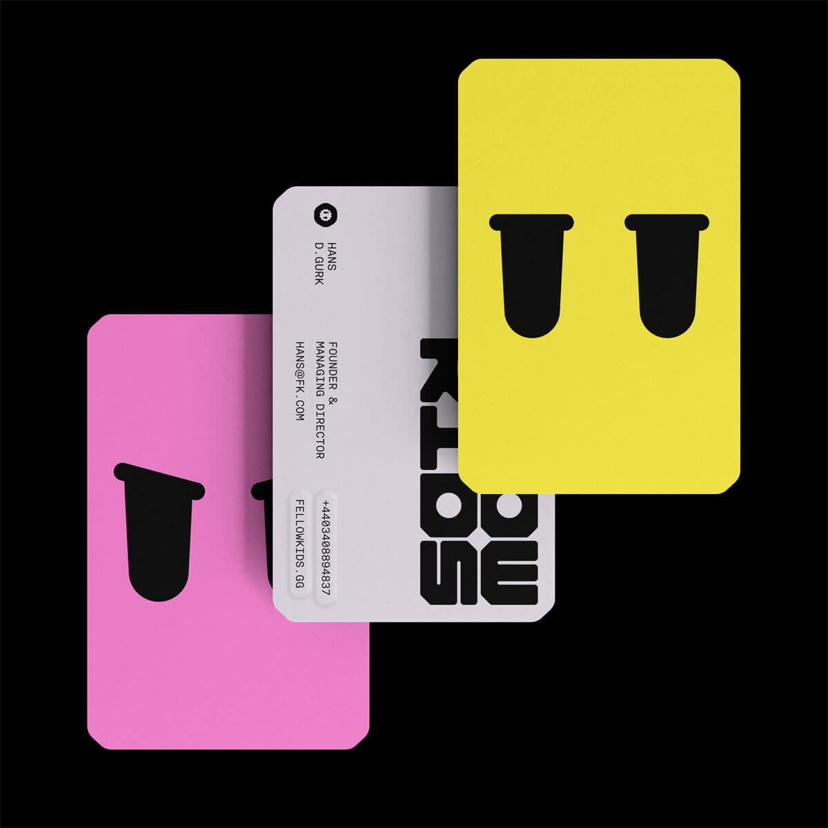 Business cards in three colours with angry and dismayed graphic eye expressions designed by Studio Kiln as part of their Fellowkids rebrand / brand identity.