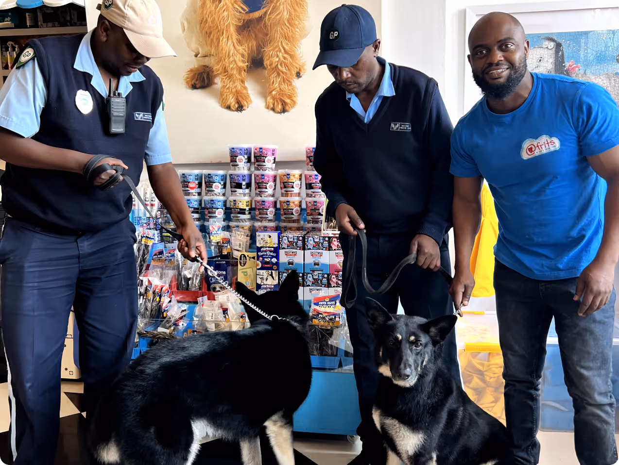 atFrits Dog Hotel team washing a security guard's dog for free in Cape Town, part of a community upliftment partnership with GP/OK to provide essential hygiene and care for local working dogs.