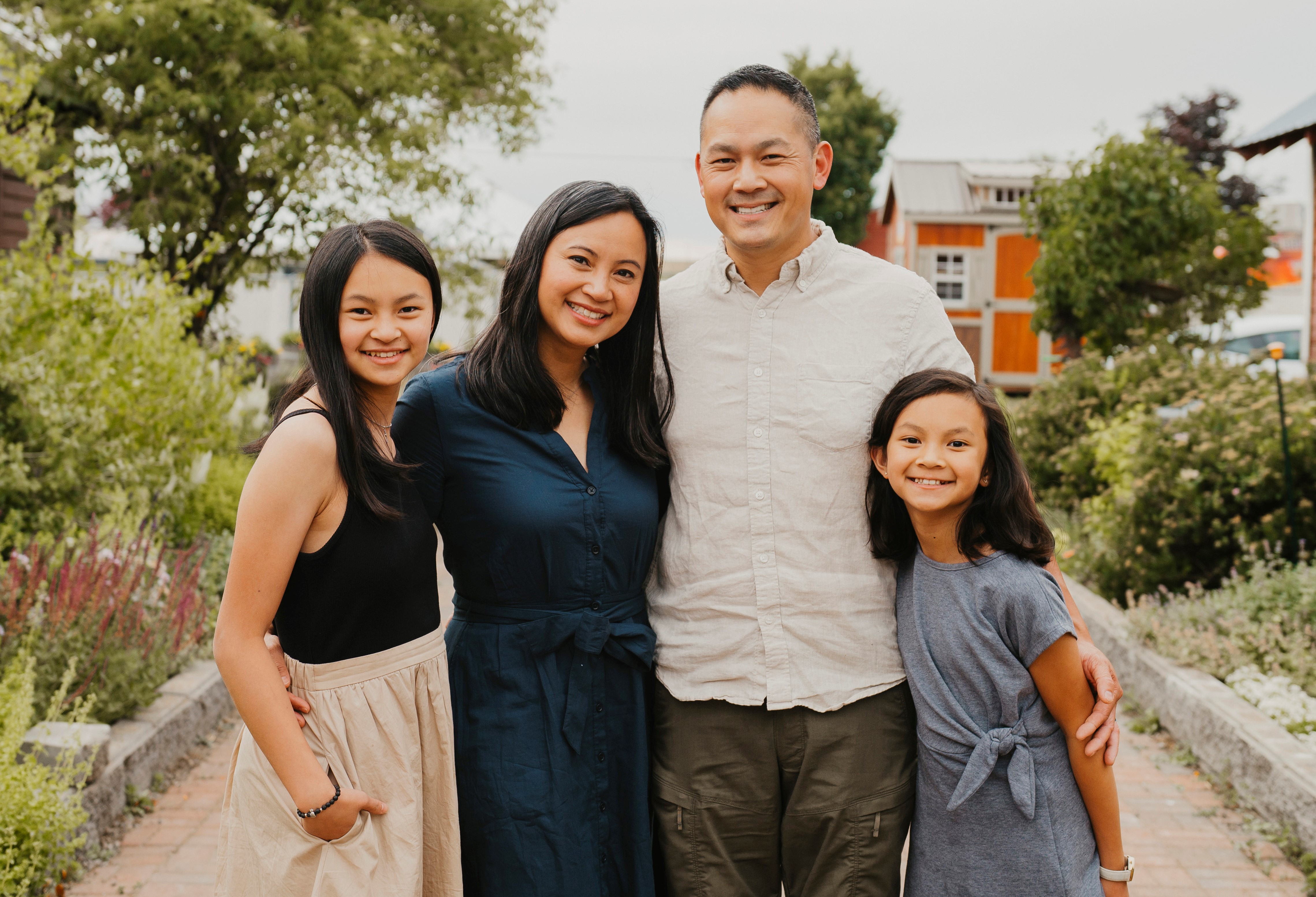 Tim & Sophia Eng and family smiling at camera.